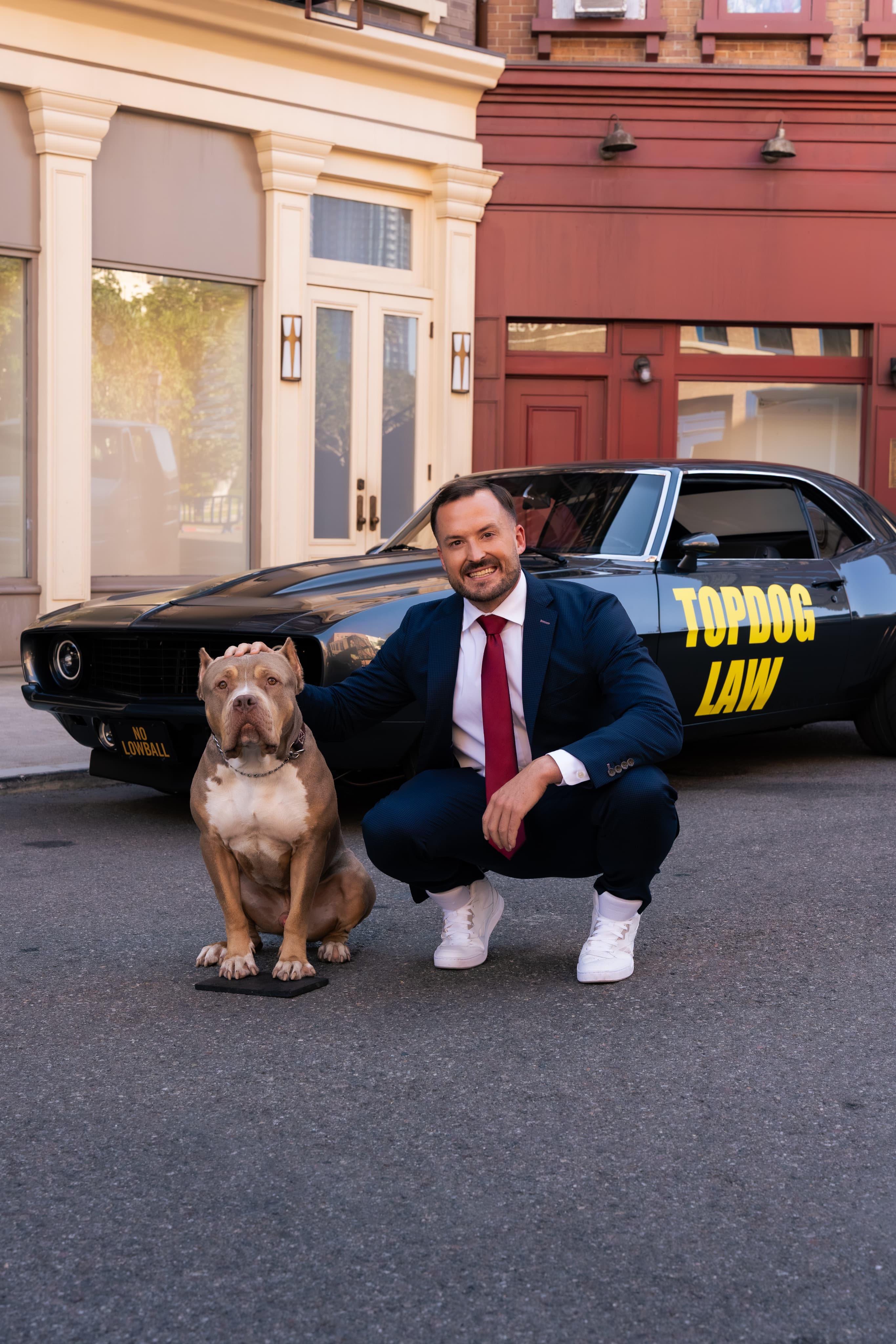 James Helm with the TopDog mascot beside a branded vehicle