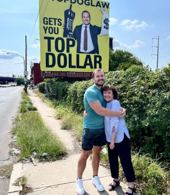 James with her mom, standing proudly at TopDog billboard