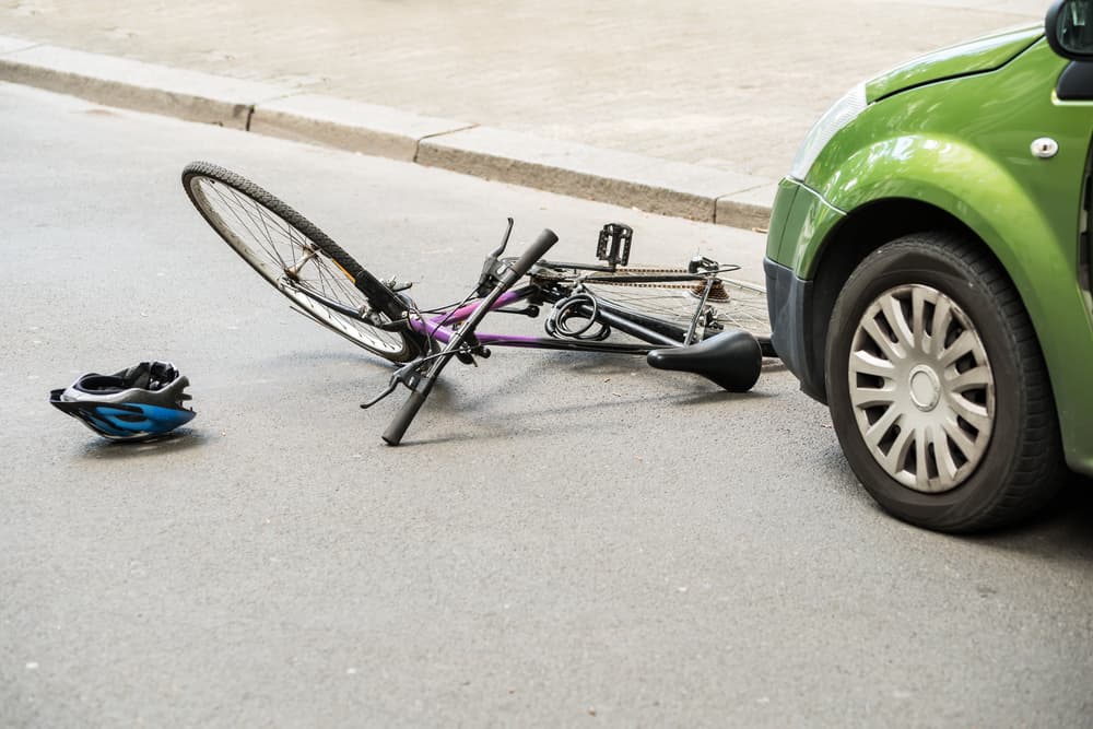 Close-up view of a bicycle accident scene on a busy city street.
