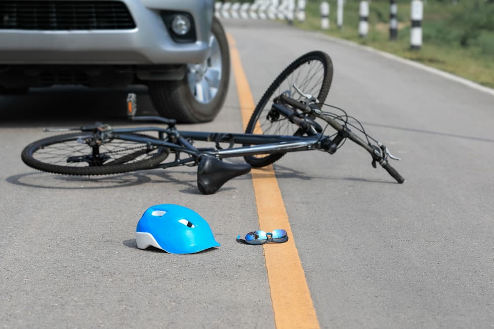 Collision between a car and a bicycle on the road.