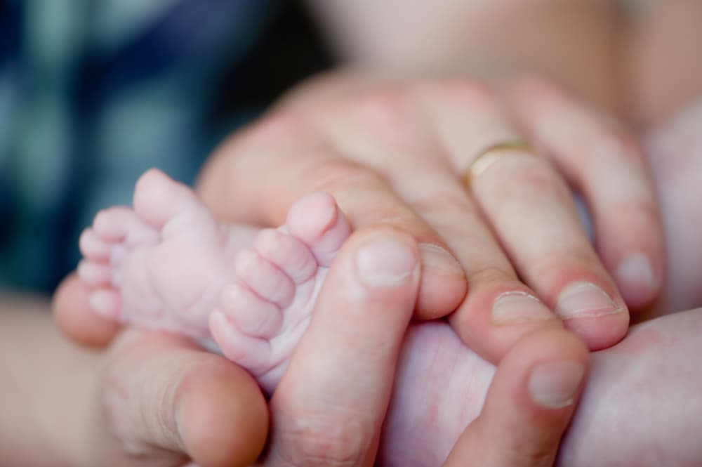 Soft newborn baby feet. Tiny toes of a gentle infant.