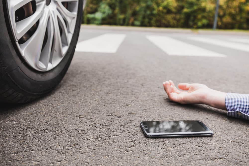 Close-up of a pedestrian struck by a car while crossing the street.