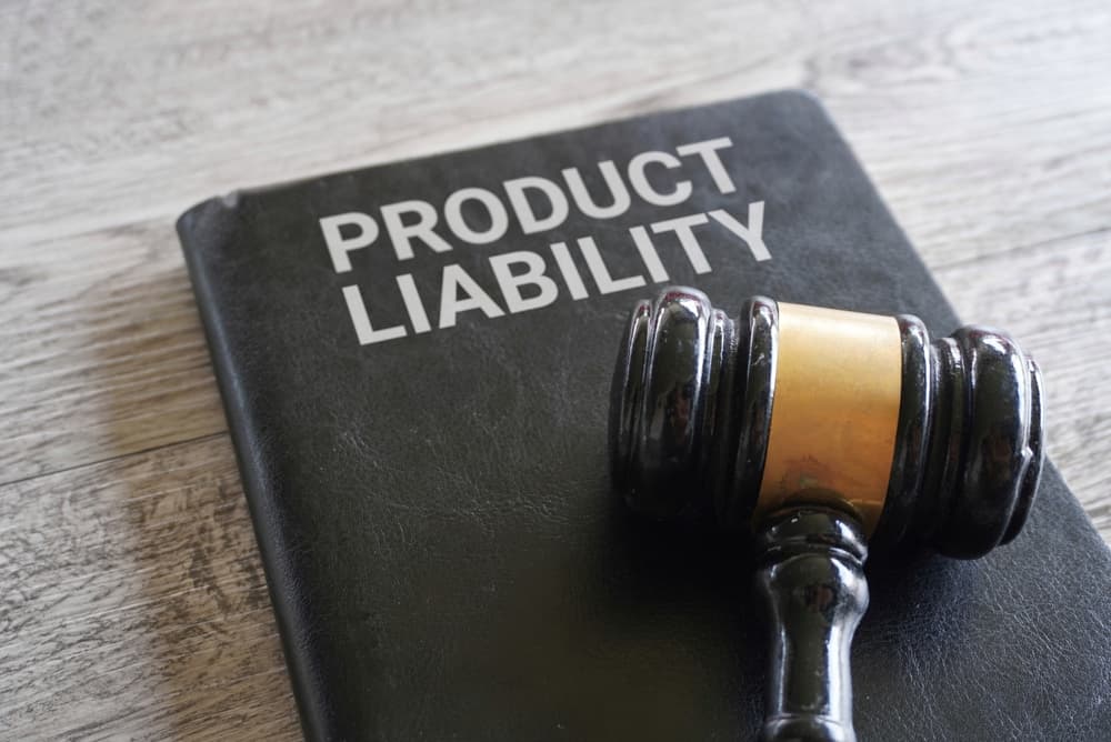 Close-up image of a judge’s gavel next to the text “PRODUCT LIABILITY” on a table.