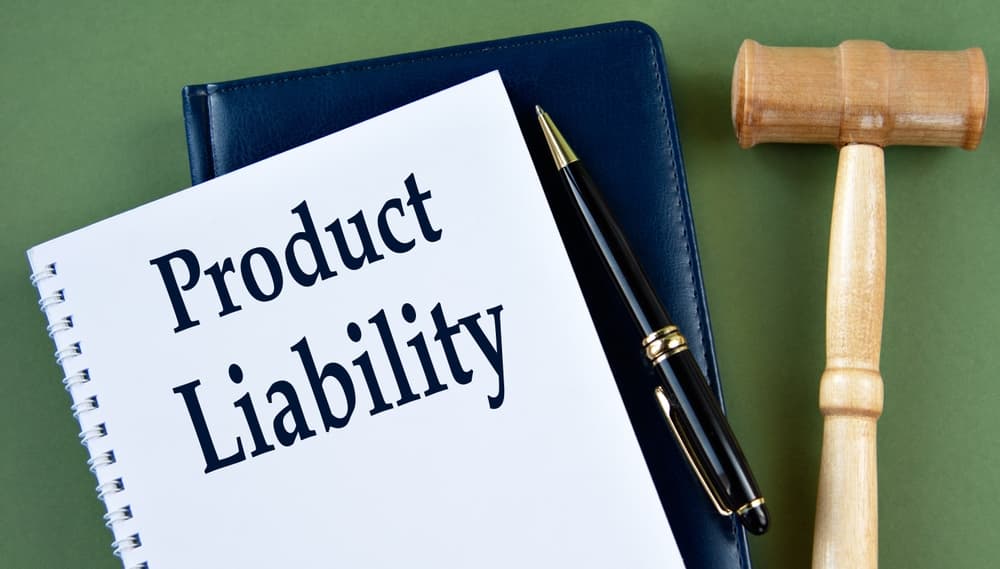 "Product Liability" written on a white sheet next to a judge's gavel.