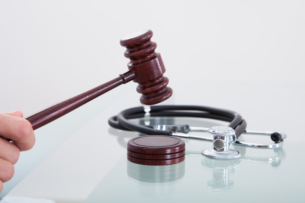 A judge's gavel and stethoscope symbolize justice in a medical malpractice case, representing legal action over healthcare negligence.