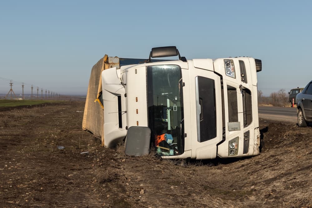 The large truck rests in a roadside ditch after the accident.