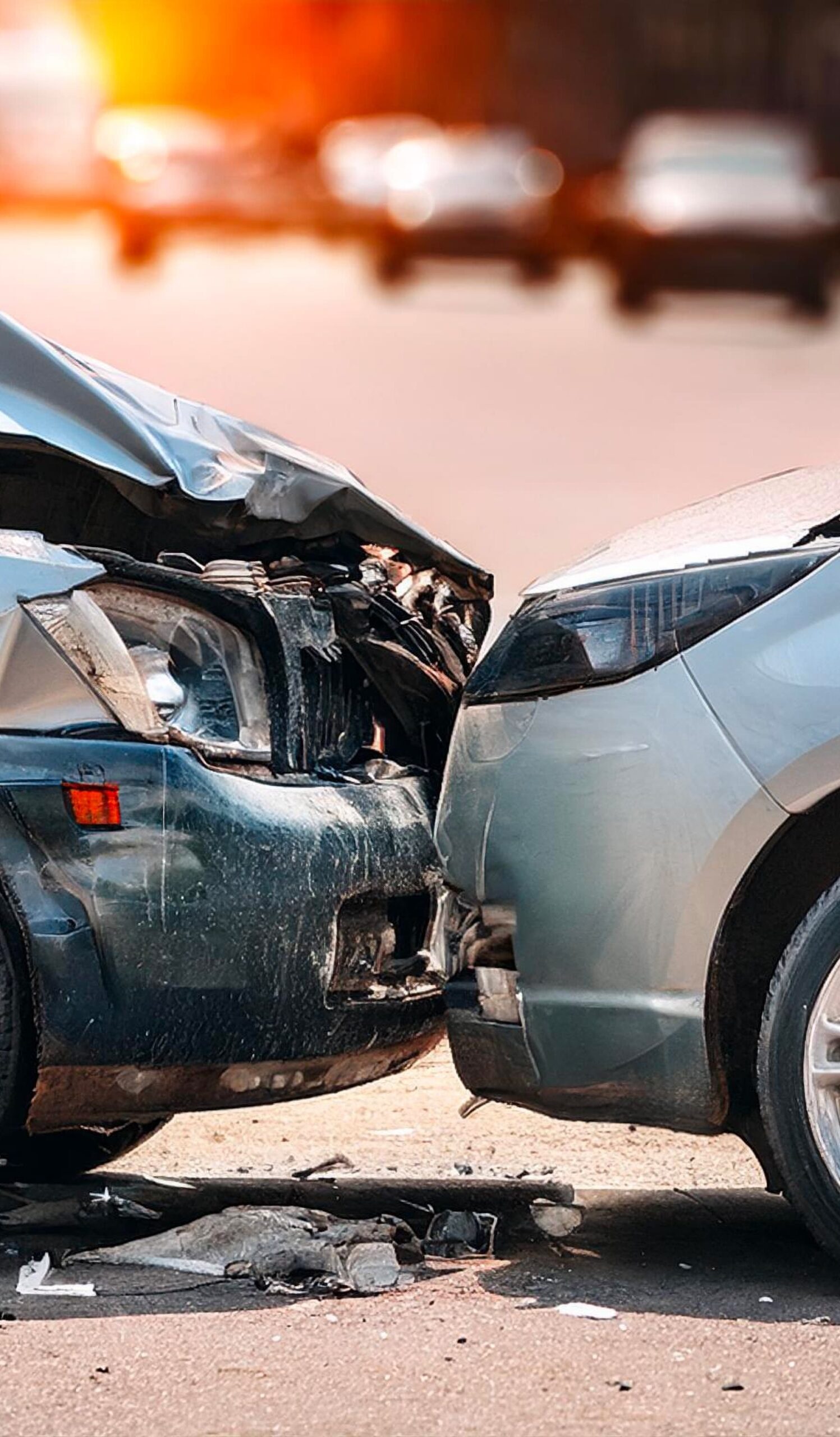 Two cars involved in a severe traffic accident with front-end damage on an urban street.